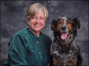 Woman next to Australian shepherd dog