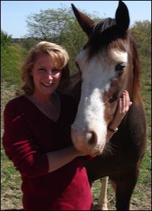 Woman standing next to horse