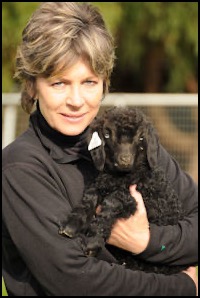 Woman holding small black dog
