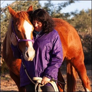 Woman in purple jacket with red horse