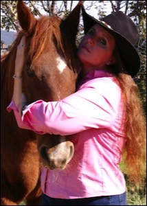 Woman in hat holding horse