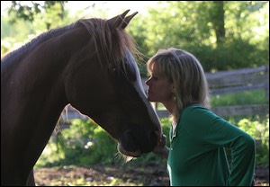 Woman with chin on horse