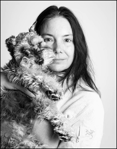 Woman with dog held by her face