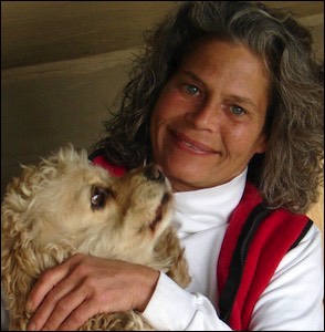Woman smiling holding poodle